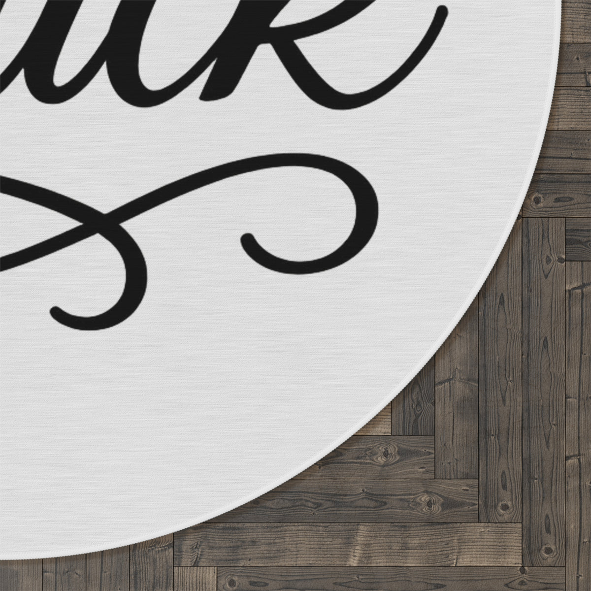 White round chenille rug printed with large black script FUCK lettering