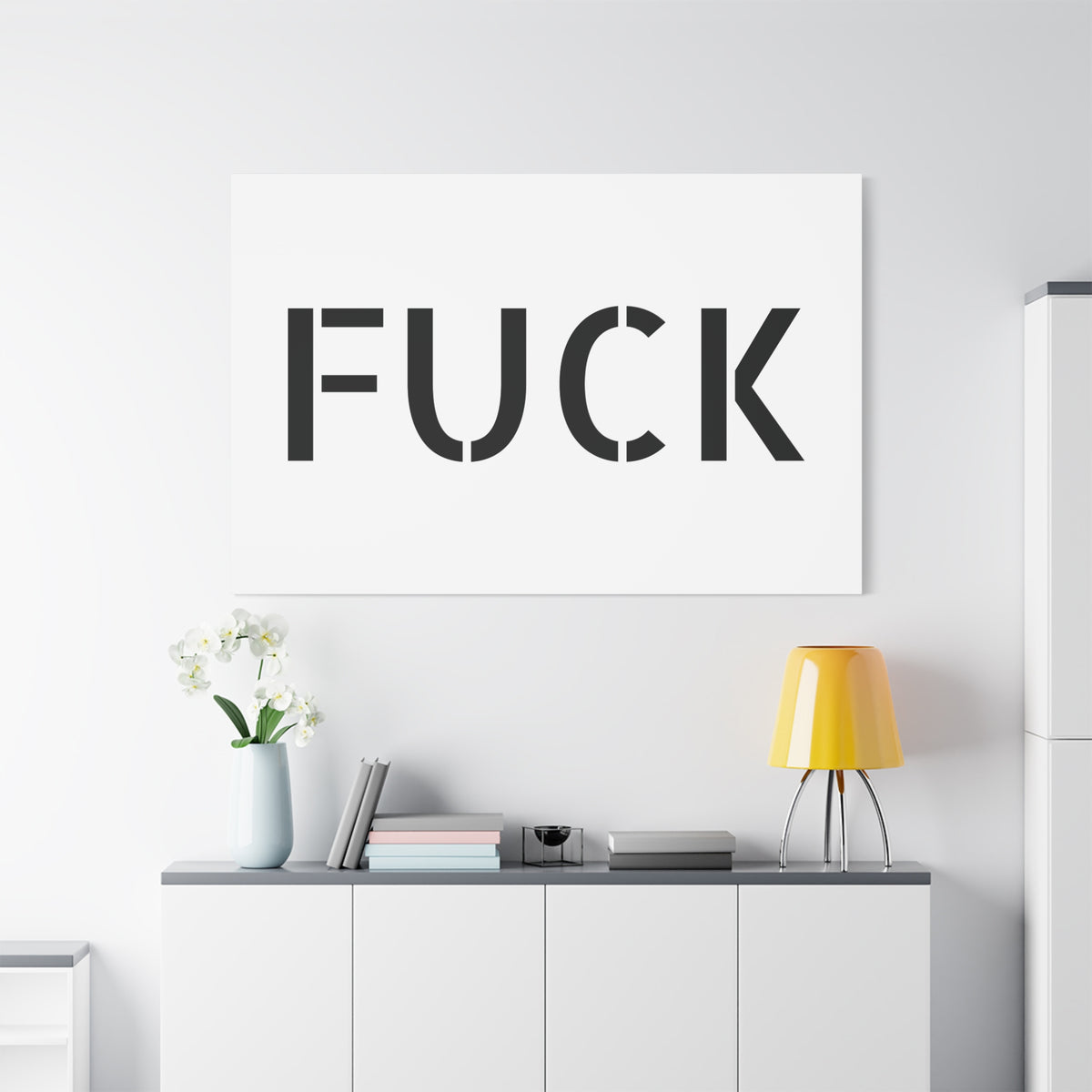 White stretched canvas printed with large minimalist black FUCK typography