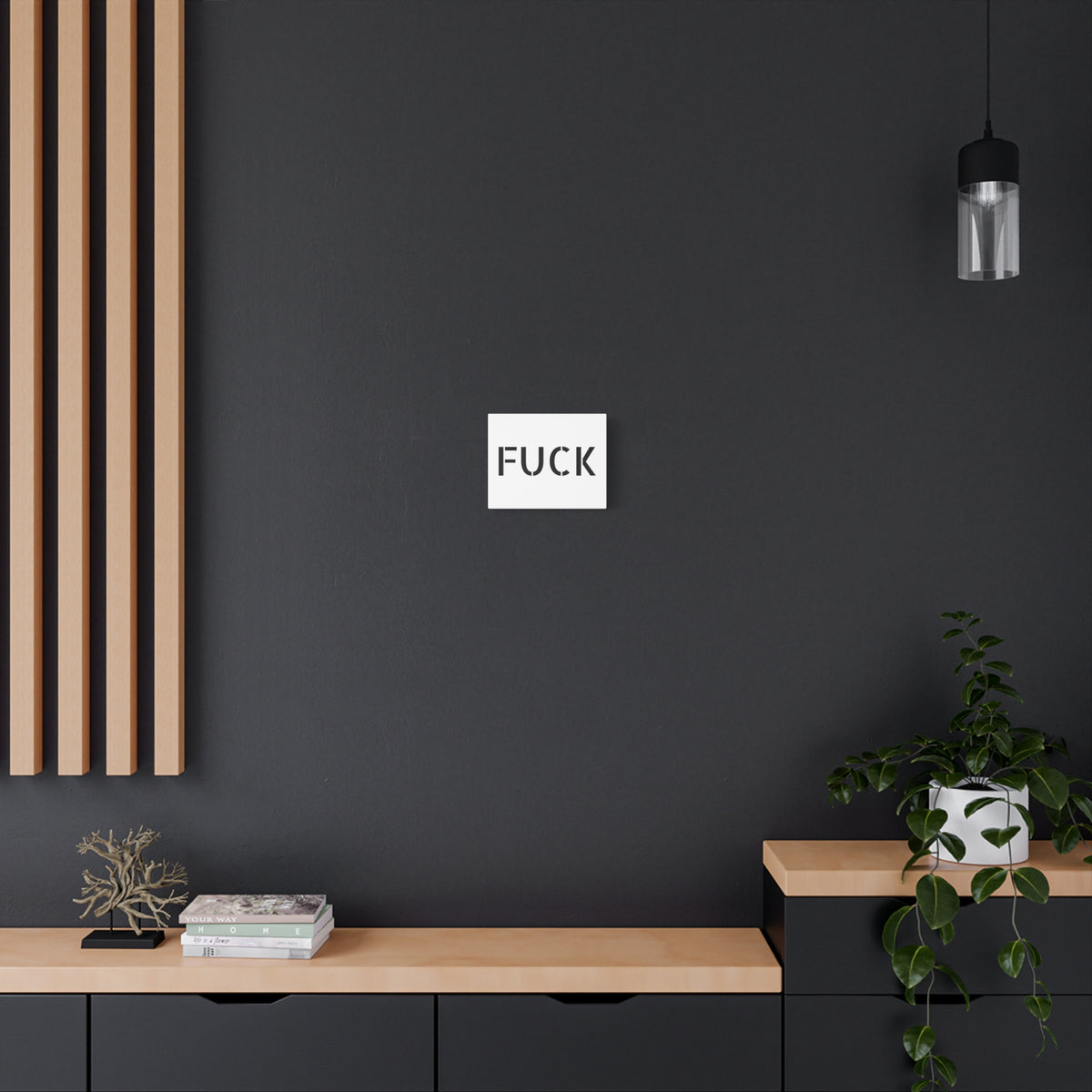 White stretched canvas printed with large minimalist black FUCK typography