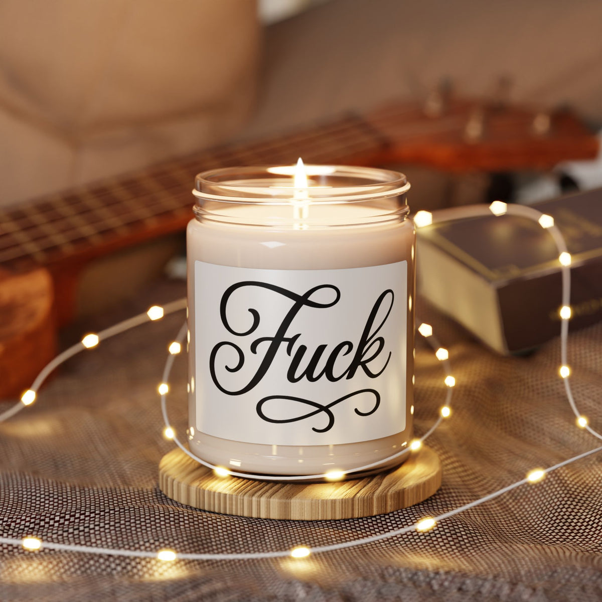 Nine-ounce glass soy candle with black lid and black script FUCK label