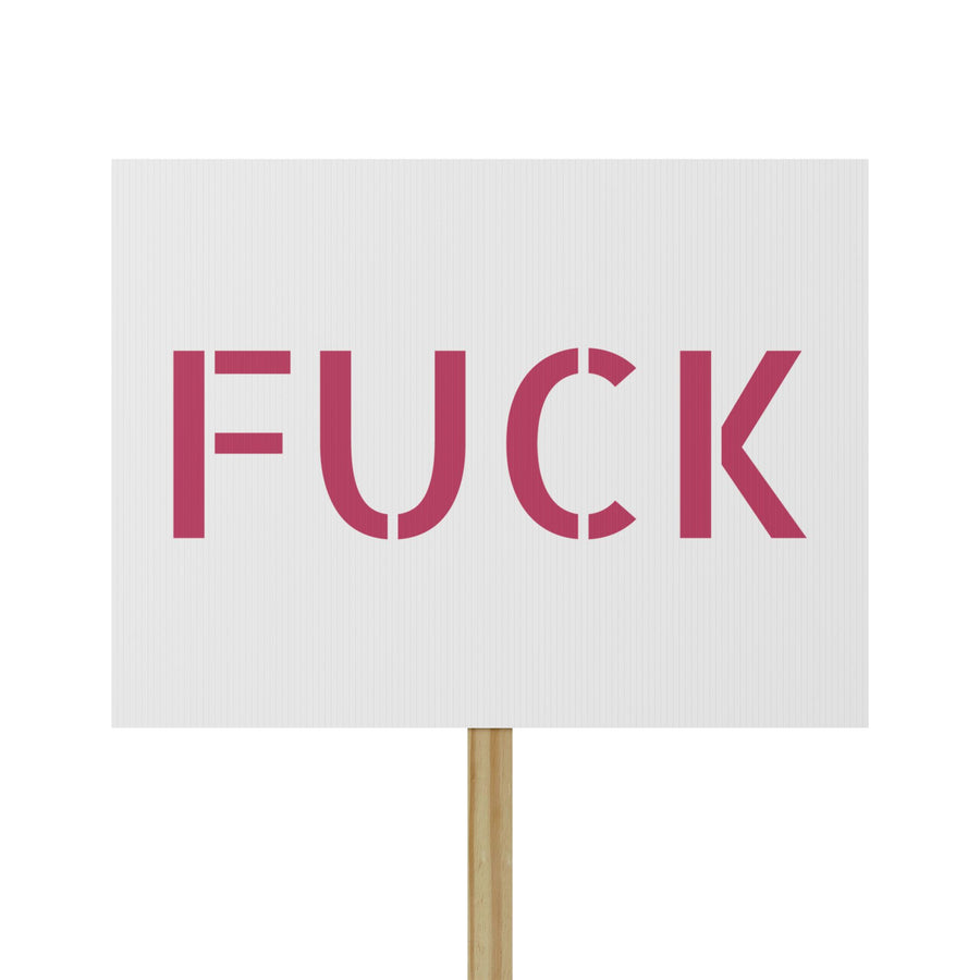 White protest sign with oversized motel-pink FUCK typography mounted on a pine handle