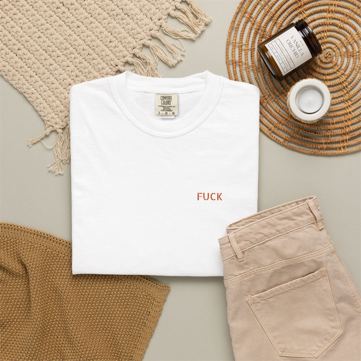 White T-shirt with tiny understated FUCK embroidery at the left chest