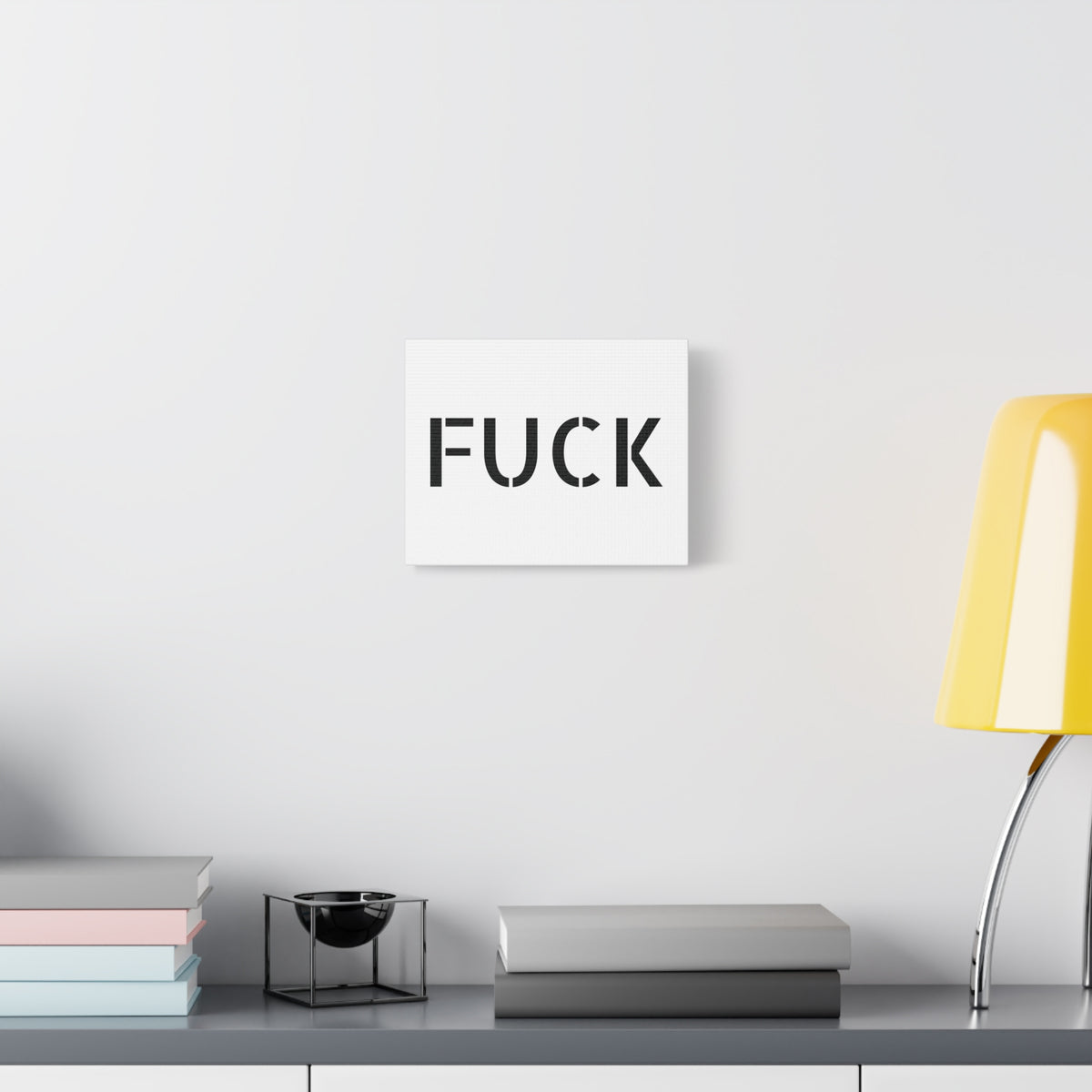 White stretched canvas printed with large minimalist black FUCK typography