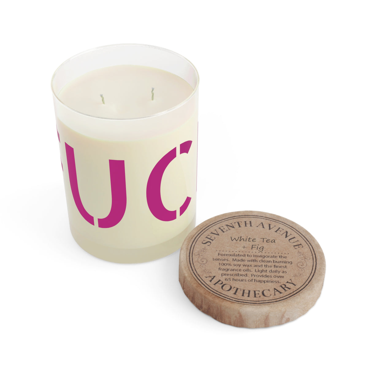 Glass candle with oversized motel-pink FUCK typography on a cream label