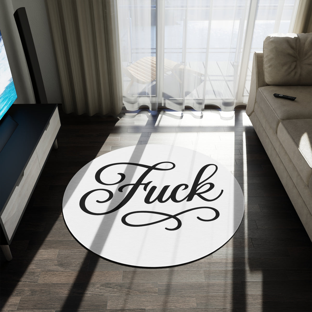 White round chenille rug printed with large black script FUCK lettering