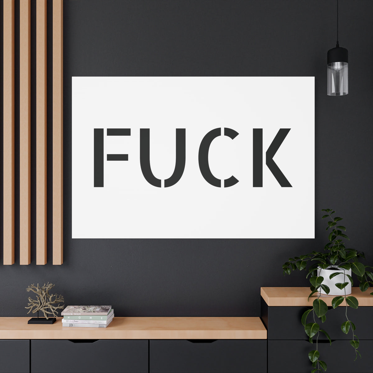 White stretched canvas printed with large minimalist black FUCK typography
