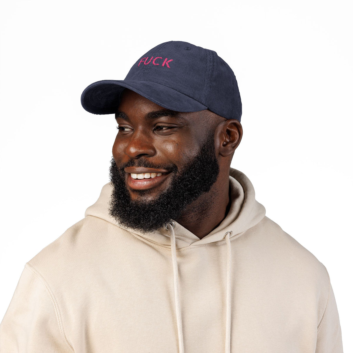 Brown corduroy cap embroidered with small motel-pink FUCK lettering