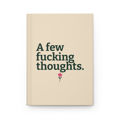 Cream hardcover journal with evergreen lettering reading A few fucking thoughts. and a small pink wildflower beneath the text.