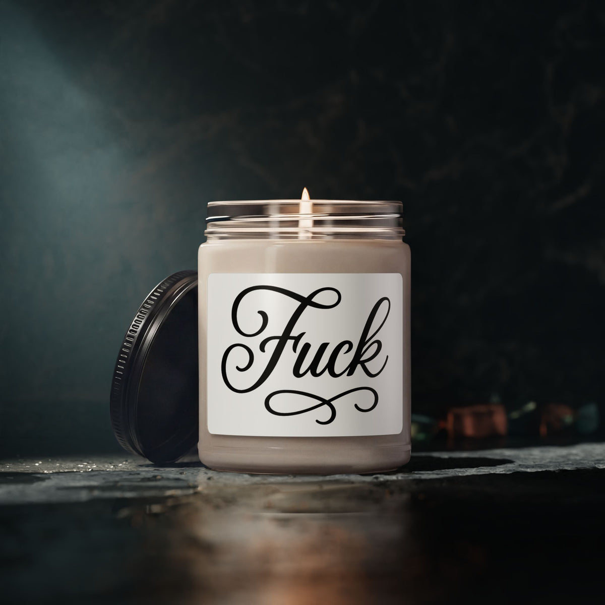 Nine-ounce glass soy candle with black lid and black script FUCK label